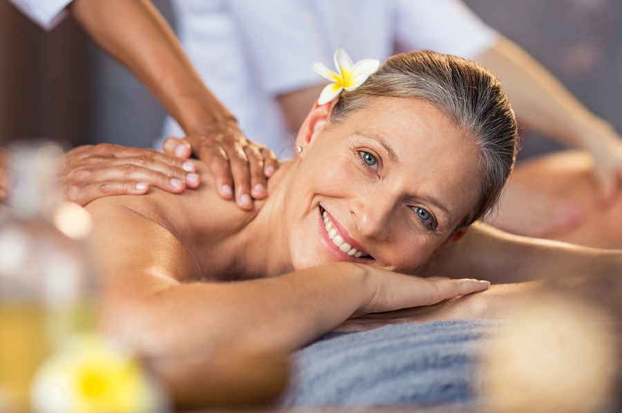 Happy senior woman getting a massage