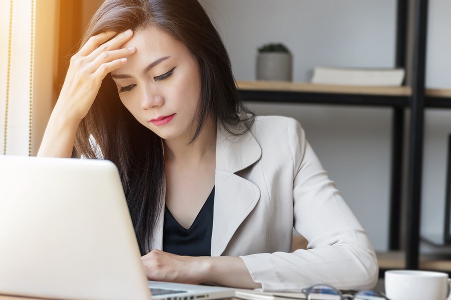 young business woman stressed looking at computer