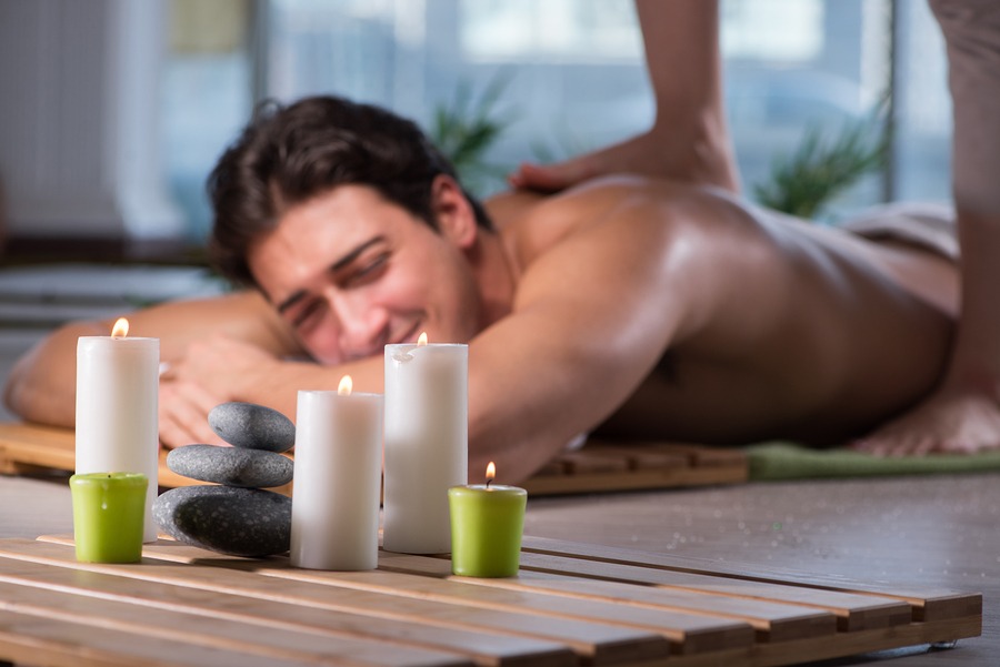 Dealing with chronic pain in New York, NY , Massage & SPA, Thai massage. Young handsome man during spa procedure in New York Spa massage , Juvenex Spa