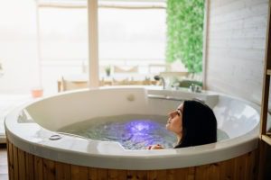Woman having a spa day moment in indoor Spa .Relaxing at spa in the hot tub bath. New Year Holiday getaway Gift Card New Year's day getaway Massage Spa Package for two in Manhattan NYC, New York