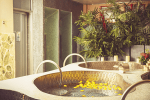 Luxury soaking tub with floating lemons and bamboo in the background